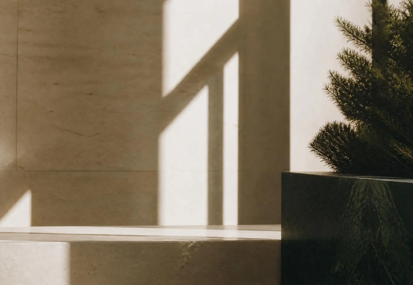 Light and shadow across a limestone wall in the Northbridge Advisory offices